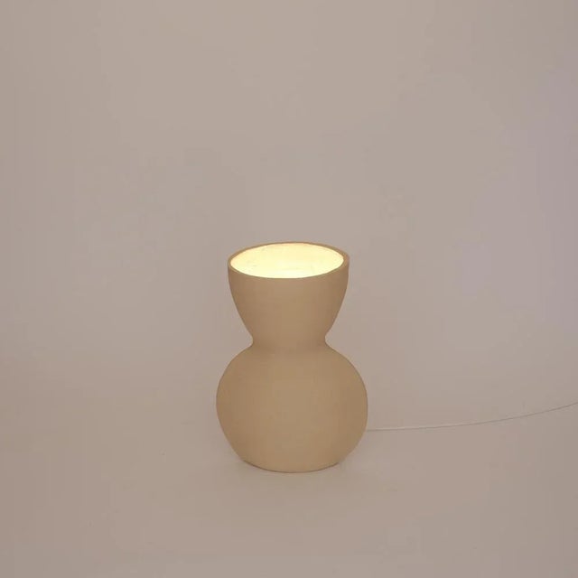 Unira small white lamp by ia kutateladze one of a kind. Dimensions: d 14 x w 18 x h 25 cm. Materials: clay. Each piece is...