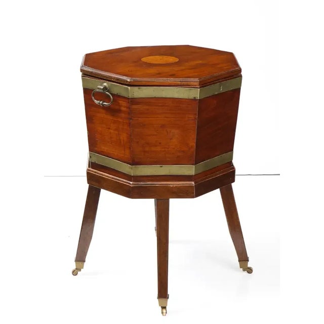 This handsome 19th-century mahogany cellarette is octagonal in shape and features beautiful brass banding, hardware and...