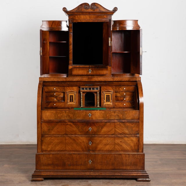 19th-century Danish secretary or "bureau" crafted in mahogany veneer with bowfront cabinet doors and refined proportions....