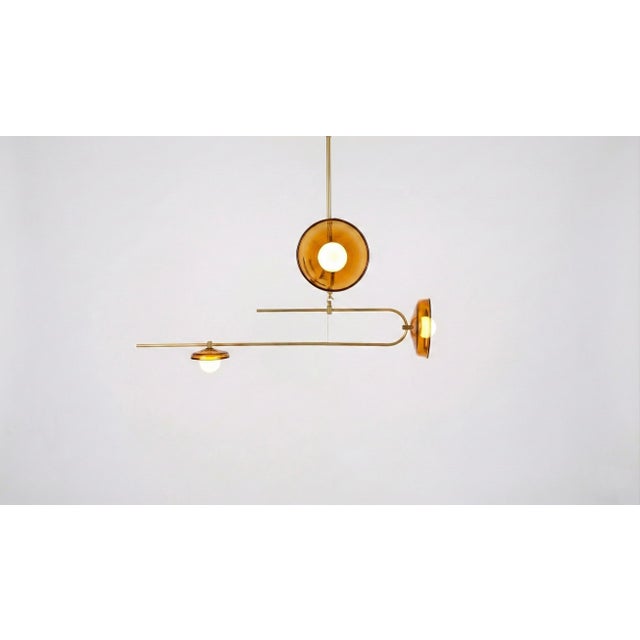 This pendant light focuses on the balance between weight and transparency. Defined by brass rod framework, the design...