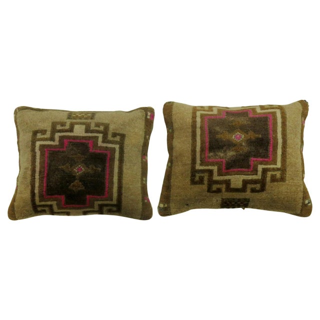 Two pillows made from a Turkish rug with pops of pink. Measuring 16" x 20" respectively.