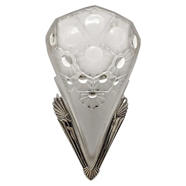 A pair of French Art Deco wall sconces by the French artist " Muller Freres ". Molded clear frosted glass shades decorated...