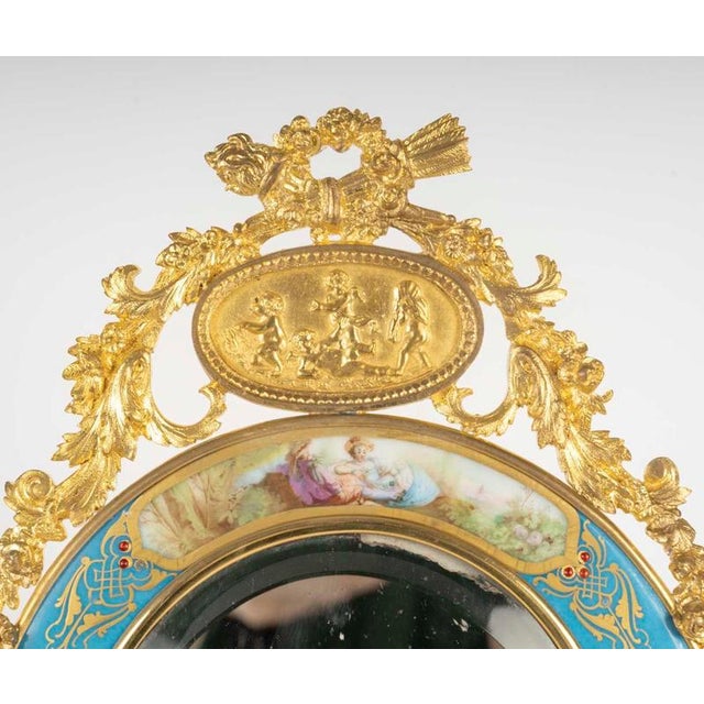 A napoleon iii period gilt bronze and sèvres enamelled porcelain table mirror, 19th century. H: 37.5cm, w: 23cm, d: 4cm
