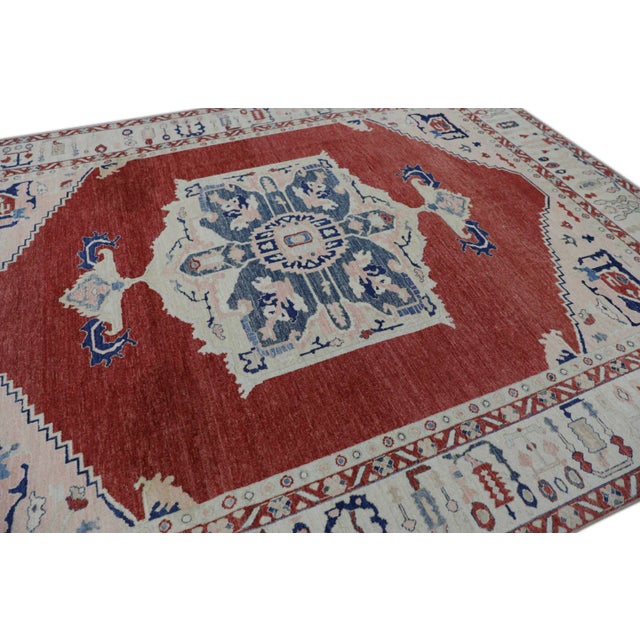 This modern finewoven Turkish Oushak rug is a stunning piece of art that has been handwoven using traditional techniques...