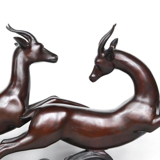 An art deco bronze sculpture of a pair of running gazelles by lucien charles alliot (1877-1967). Set in a naturalistic...