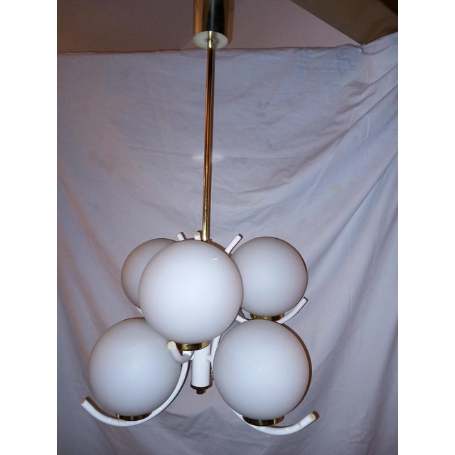 The ceiling lamp is equipped with 6x E14 sockets, fully functional, in very good condition. This piece is attributed to...