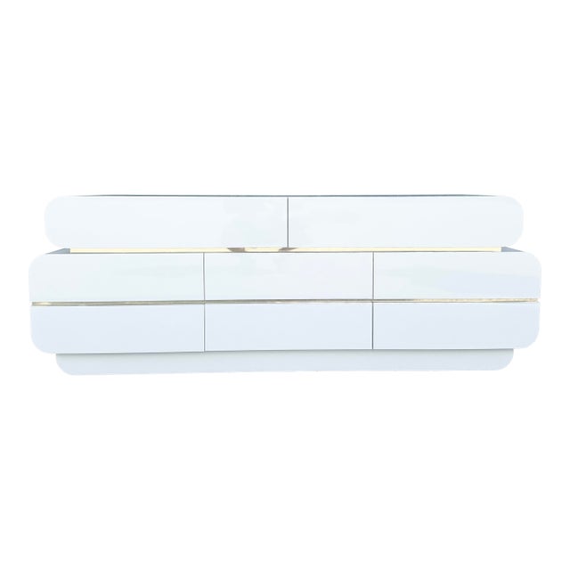 Postmodern Galactic White Gloss Laminate Waterfall Dresser With Gold Accents For Sale