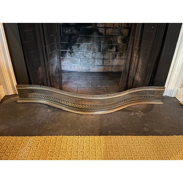 Antique early 19th century English George III brass fireplace fender for the mantel circa 1800. Serpentine shape with...