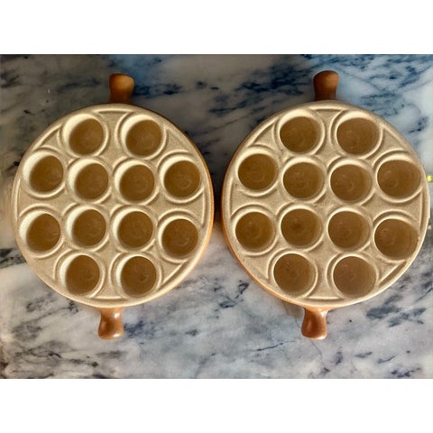 Vintage Emile Henry stoneware escargot plate, French. Plate has twelve wells and two handles, with a speckled sand glaze...