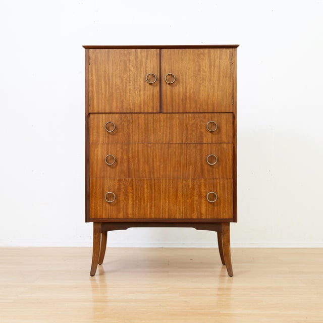 This elegant British mid-century gentleman's chest offers a refined blend of style and practicality. Crafted in...