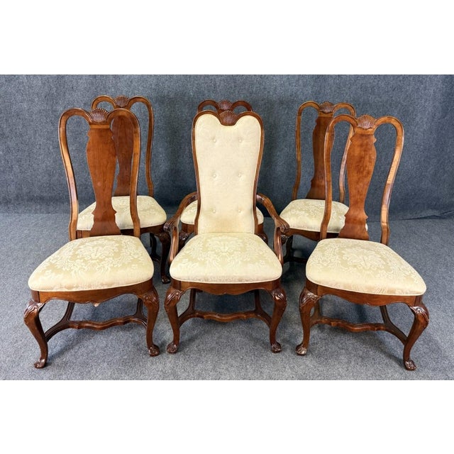This set of six Bernhardt high back cherry dining chairs features elegant carved backs, cabriole legs, and upholstered...