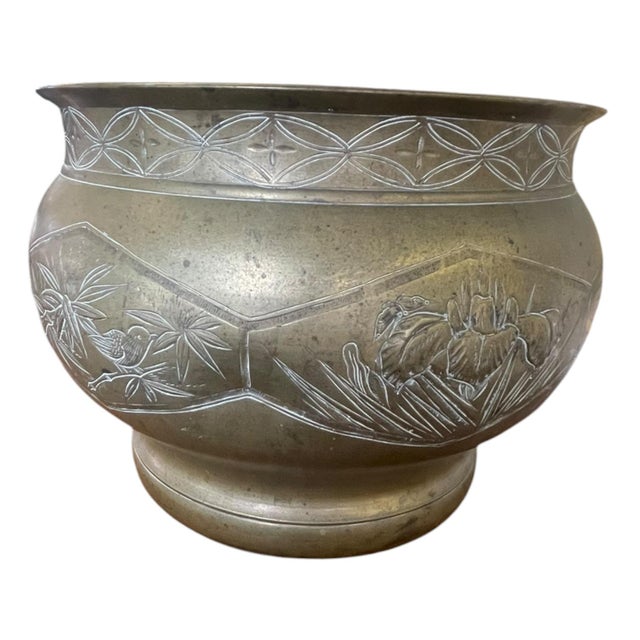 Vintage jardiniere or planter, possibly constructed of brass, featuring an engraved decorative design across the exterior....