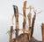 Contemporary driftwood assemblage figural sculpture. Larger wood base with eight carved stick figures with faces, fiber...