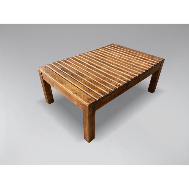 A very decorative and sturdy mid-20th-century French walnut slat rectangular top coffee table, raised on four square legs...