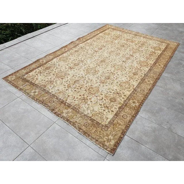 This is a vintage Turkish Oushak rug from the 1960s. The piece was hand-knotted.