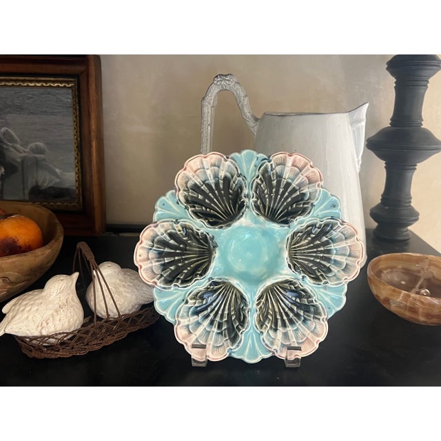 A French majolica oyster plate made by Fives Lille, at the end of the 19th century. The plate has a raised central sauce...