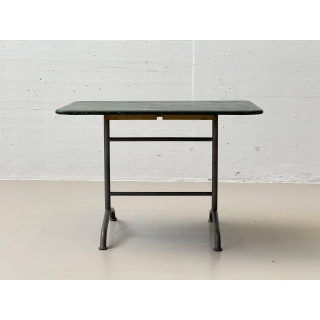 A distinctive garden table designed by max ernst haefeli for embru. Its clear, functional design exemplifies the pragmatic...