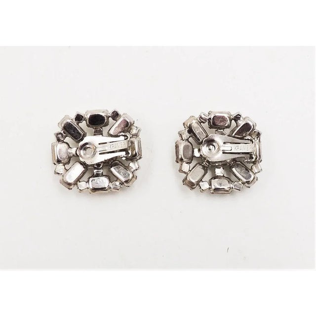 This is part of Chairish’s Costume Jewelry assortment. 1960s rhodium plated emerald cut white givre (clear with white...