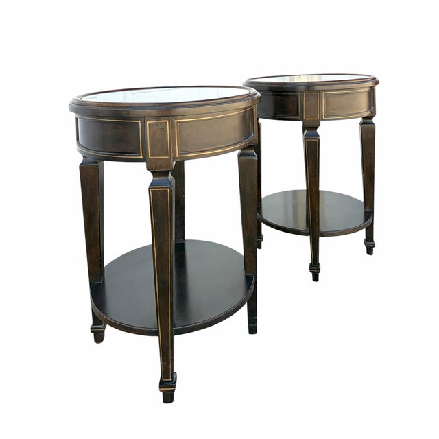Offered here is a pair of Baker Furniture Italian Neo Classical two tier side table or plant stands. Each table features a...