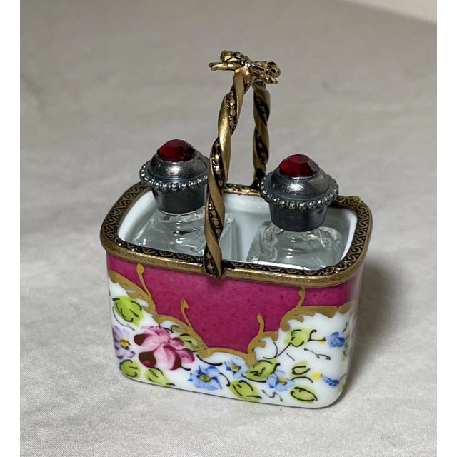 Experience the elegance of French craftsmanship with this vintage Peint Main Limoges perfume bottle trinket box. Adorned...