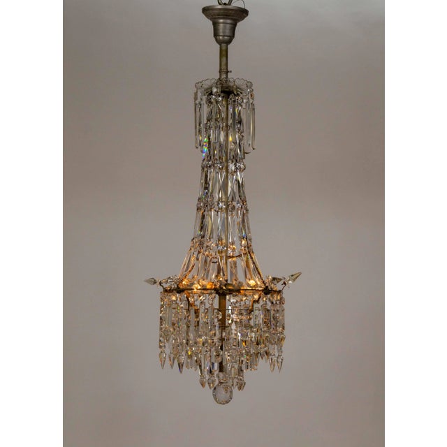 This chandelier is truly stunning, with its sparkling, leaded glass cut crystals. An Empire-style crystal chandelier in...