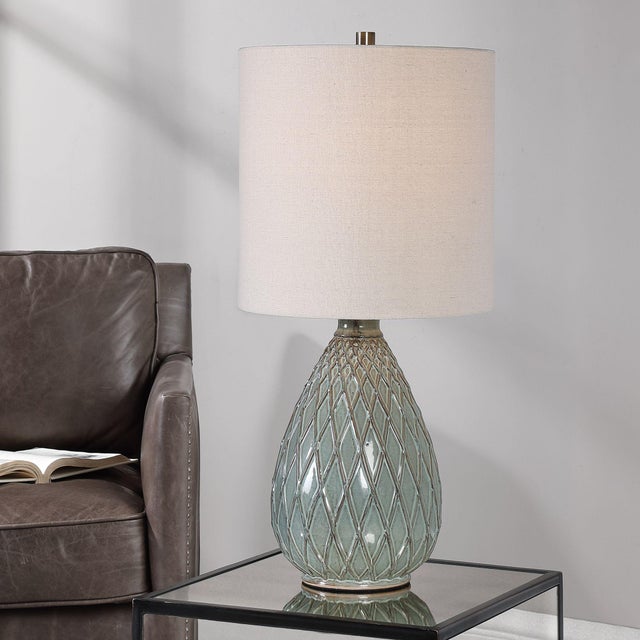 The textured pattern on this ceramic table lamp is enhanced by the rust and aqua color combination, along with the brushed...