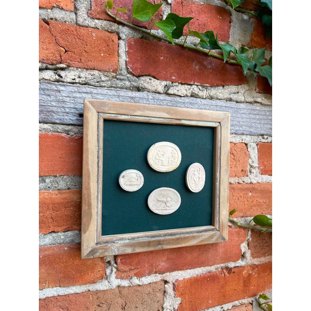 Immerse yourself in the enduring allure of classical antiquity with this truly unique collection of framed intaglios....