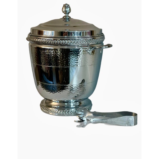 Swanky Faber Brothers hammered chrome ice bucket with matching tongs that cleverly clip to underside of top. Internal...