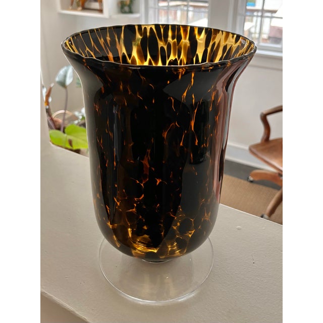 This timeless tortoise shell vase offers graceful curves and a beautiful glow in the light. Equally at home empty or...