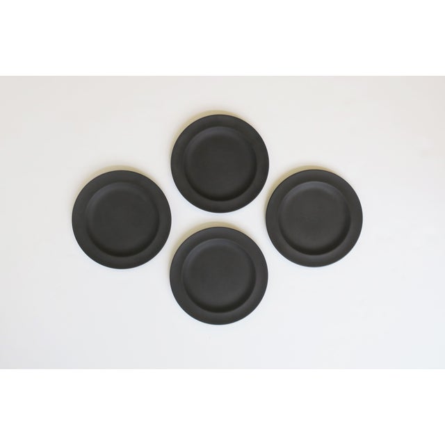 A beautiful set of four (4) English Jasperware matte black basalt plates by Wedgwood, England, 1970. With maker's mark on...