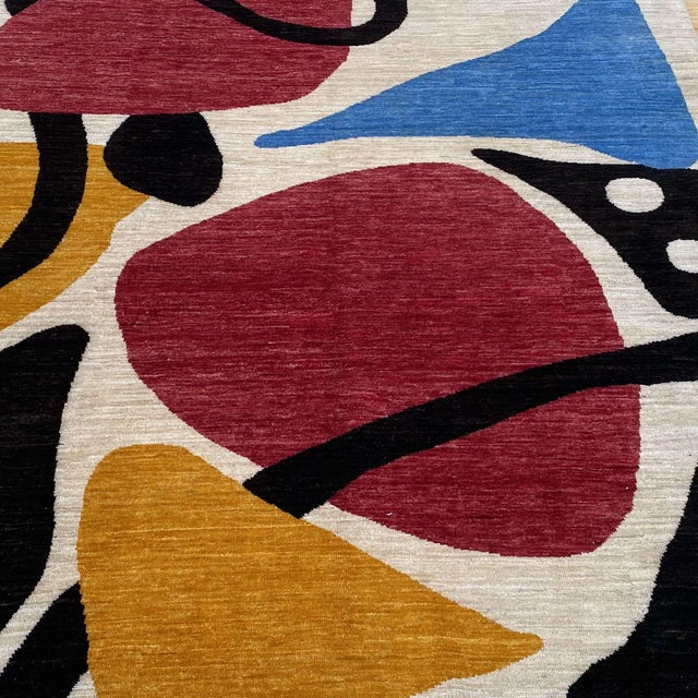 After Alexander Calder — a captivating hand-knotted modern art rug inspired by the iconic biomorphic compositions of...