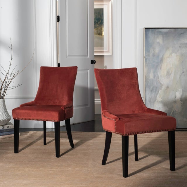 Low sloped arms and a slight hourglass shape to the seat back define this set of two dining chairs upholstered in cotton...