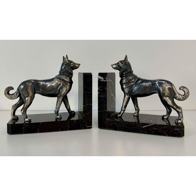 Elegant pair of French Art Deco bookends produced during the 1930s. Each bookend features a stylized wolf dog standing...