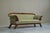 Sculptural Regency Sofa in Figured Mahogany Veneer and Velvet Early 19th Century A large and sculptural regency sofa in...