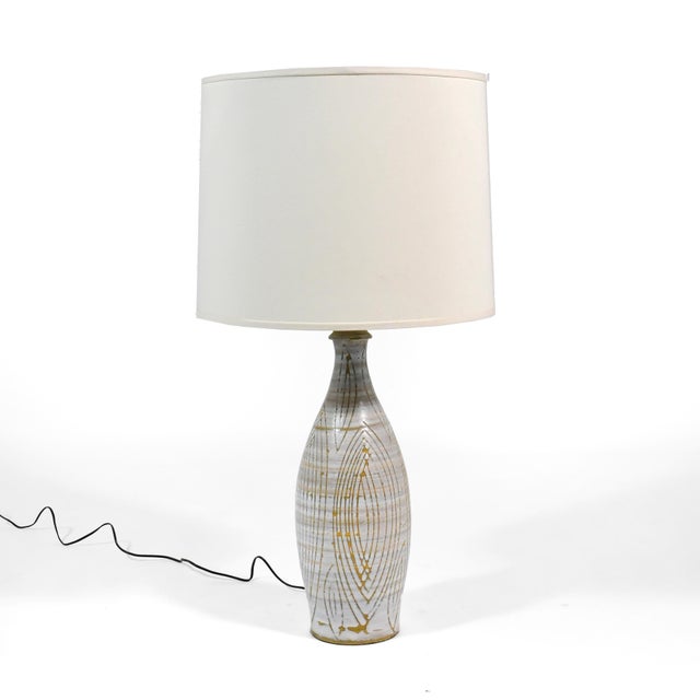 This strikingly beautiful lamp has a base of ceramic decorated with a ivory glaze that has an all-over sgraffito design....