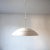 A half circle pendant light by British company Thorn Lighting. This piece is attributed to the mentioned designer/maker....