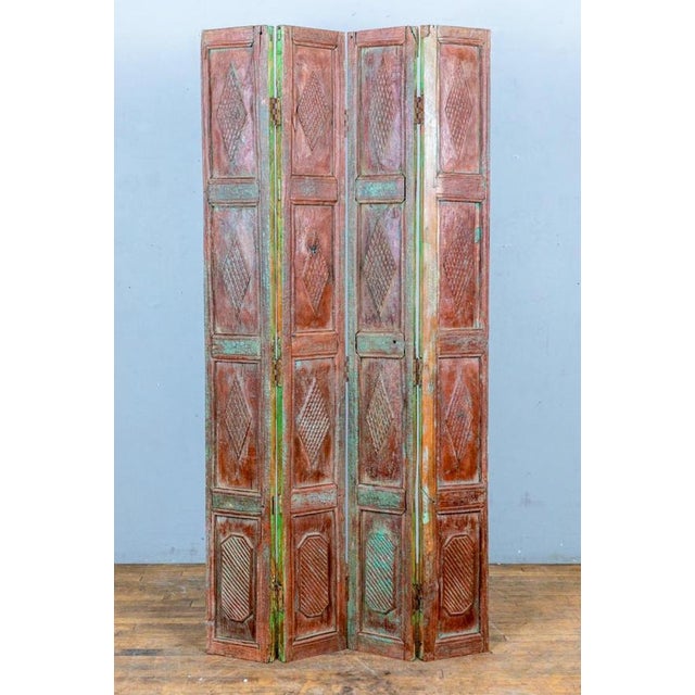 This elegant pair of 19th-century Indian teak bifold panelled doors beautifully combines craftsmanship with a rich...