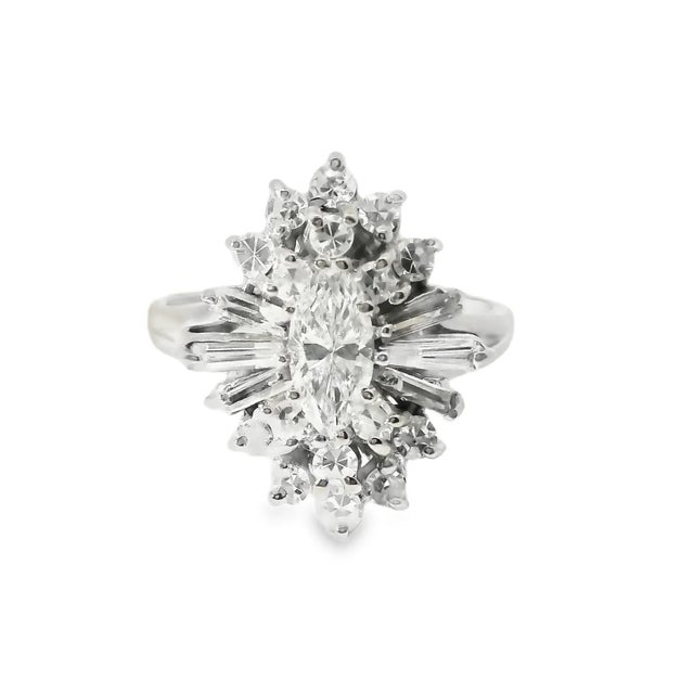 Elegant 14K yellow gold diamond engagement ring featuring a stunning 0.8 ct marquise center diamond, accented by 16...
