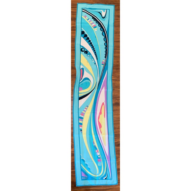 This vibrant Emilio Pucci retro-print long silk scarf features a fluid, geometric turquoise and multi-color abstract swirl...