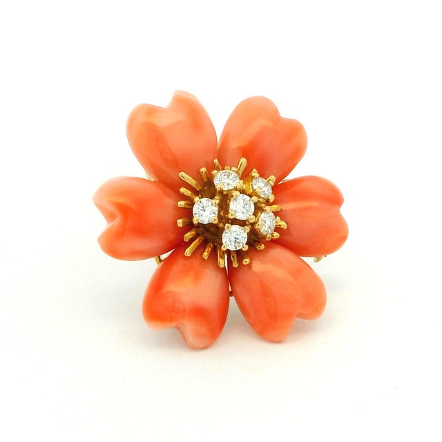 Elegant vintage flower brooch and pendant crafted in 18K yellow gold, featuring six individually carved coral petals...