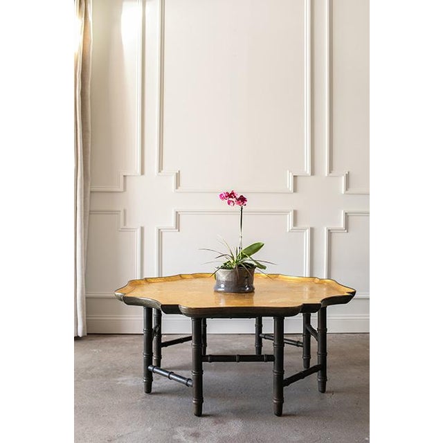 This exceptional Hollywood Regency coffee table is a hallmark of Kittinger Furniture Company's prestigious craftsmanship....