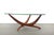 A boomerang glass top in pristine condition sits on a sculptural walnut base in this 1960s Forest Wilson table. Thick,...
