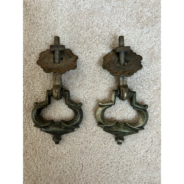 A handsome pair of antique French brass drawer pulls featuring elegant rosette backplates and classic bail handles. These...