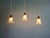 Trio of Art Deco pendant/portable lamps in clear glass, 1920s-30s. Each lamp has been restored and is compatible with an...