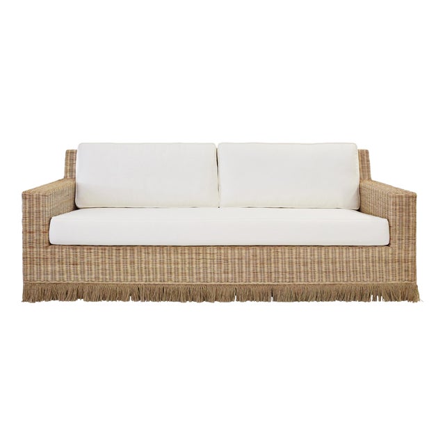Matthew Izzo Home - Tenny Rattan Sofa With Fringe Skirt and Ivory Linen Cushions For Sale