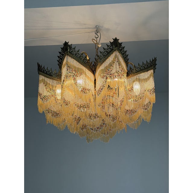 Art Deco 9-light chandelier with colored fringes, 1940s Good condition, with small losses to the fringes. E14 bulbs. Brass...