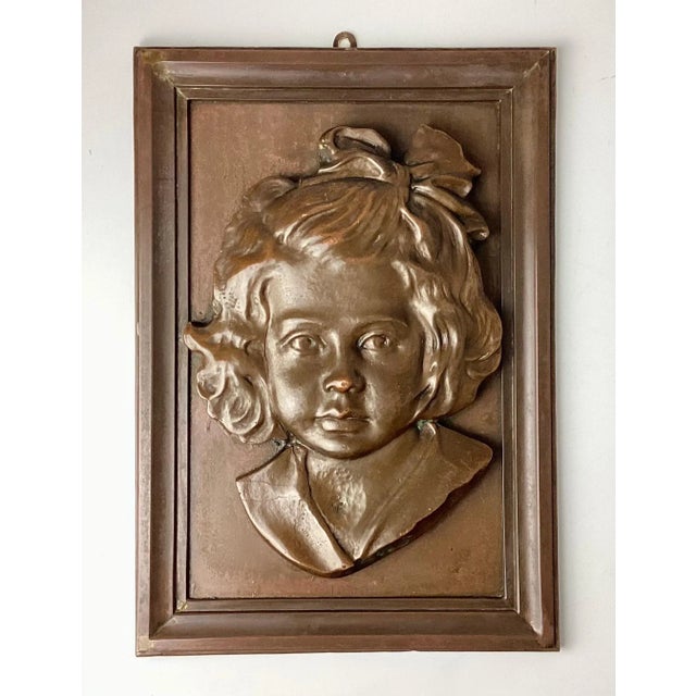 Bronze Portrait Plaque of a Young Girl. She is made of bronze and mounted on a bronze frame. No markings. Well done. Hook...
