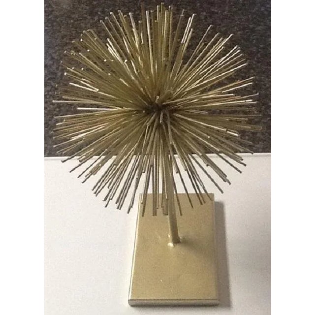 The minimalist design of this piece resembles the Brutalist style of Curt Jere from the 1970's. It features a cluster of...