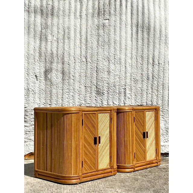 Add a touch of bohemian elegance to your space with this stunning pair of vintage chevron reed nightstands. Featuring a...