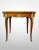 Inlaid Fruitwood Coffee Table. With brass ormolu mounts adorn the apron, shoulders and feet. Beautiful red, cream and...